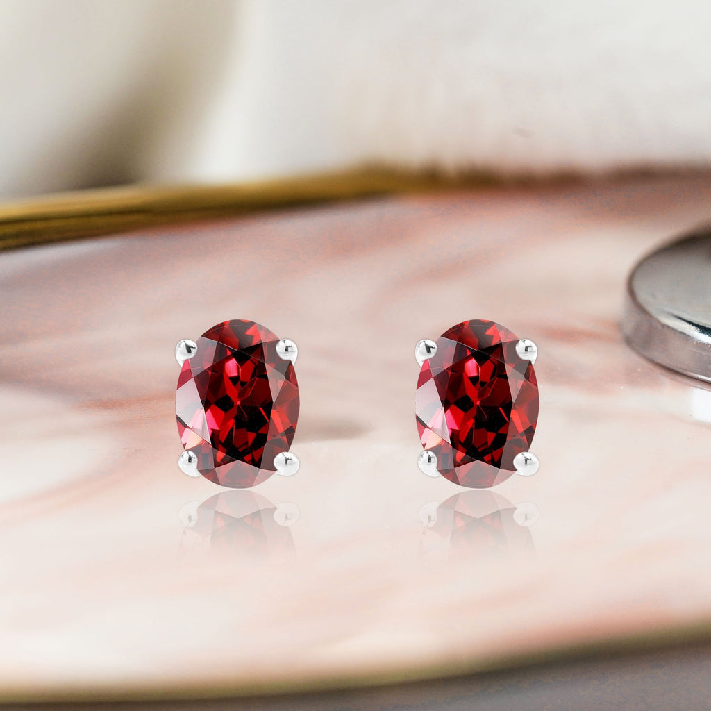 2.5 Carat Oval Cut - SWAROVSKI Garnet - January Birthstone Solitaire Stud Earrings - 4 Prong - In 18K White Gold Plating Over Silver