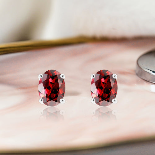 2.5 Carat Oval Cut - SWAROVSKI Garnet - January Birthstone Solitaire Stud Earrings - 4 Prong - In 18K White Gold Plating Over Silver