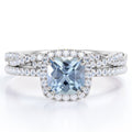 JeenMata Halo Prong Set - 1.5 Carat Cushion Cut Seafoam Created Aquamarine and Moissanite - Pave Twisted Infinity Wedding Ring Set - 18K White Gold Plating over Silver