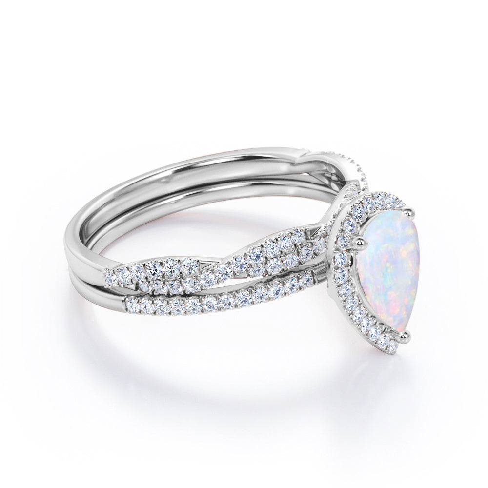 JeenMata 1.5 ct Pear Shaped Created Blue Opal and Moissanite Vintage Bridal Set - Infinity Twisted Wedding Ring Set in 18K White Gold Plating for Women