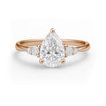1.10 Ct Pear Moissanite Tapered Side Stone Engagement Ring