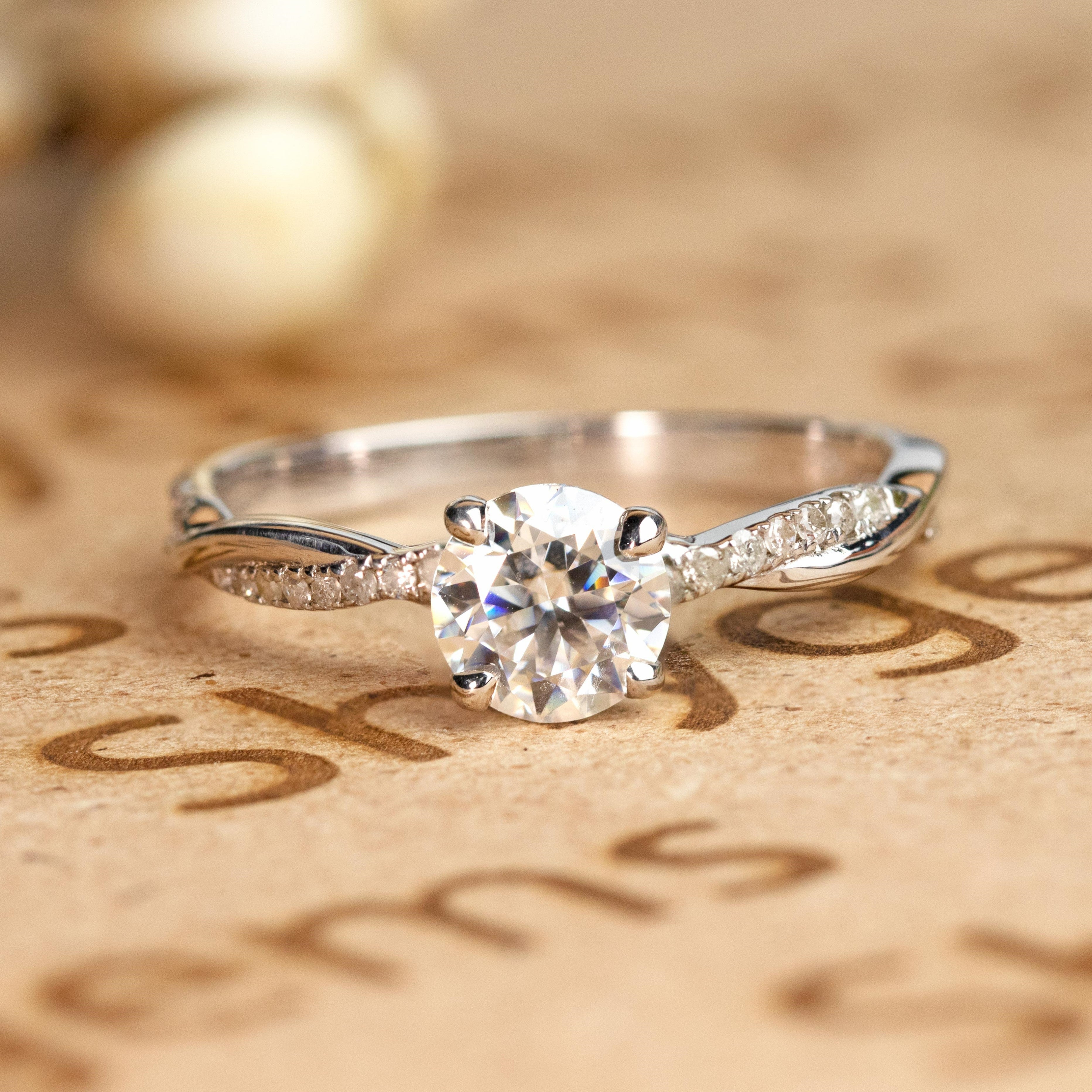 JeenMata Cathedral Prong 1 Carat Round Shaped Moissanite Half Pave Infinity Twisted Shank Engagement Ring In 18K White Gold Plating Over Silver