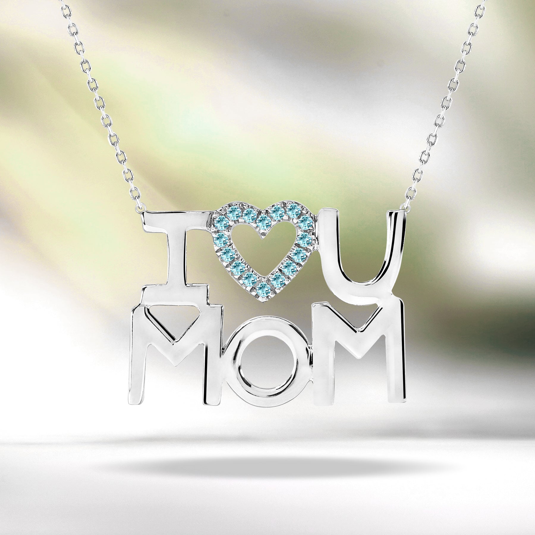 JeenMata I Love U Mom Light Blue Stone Embellished Open Heart Pendant Necklace in 18K White Gold over Silver - December Birthstone - Gift for Mom